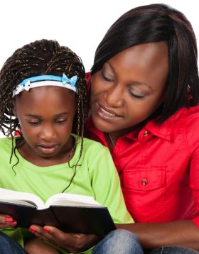 Adorable,Small,African,Child,With,Braids,Wearing,A,Bright,Green